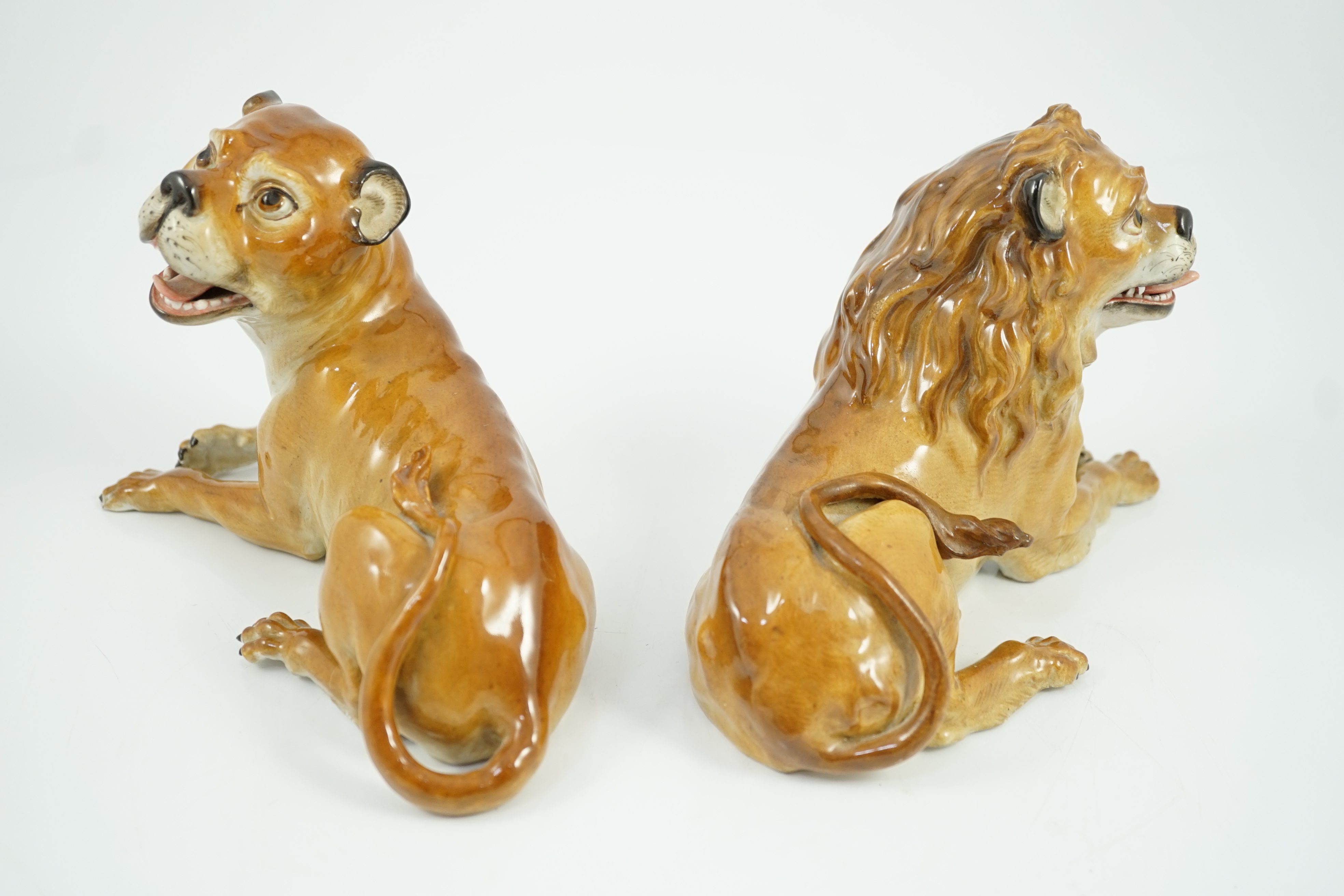 A pair of Meissen figures of a recumbent lion and lioness, 19th century, restoration